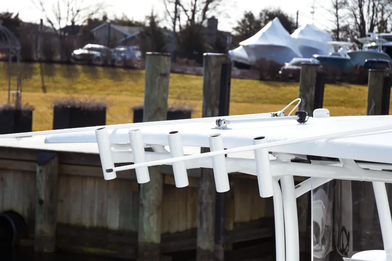 Slide: The Image of Fishing rod holders on a 2026 Jupiter 30 boat docked near a marina. - 20