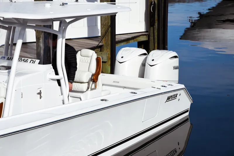 Slide: The Image of 2026 Jupiter 30 boat with dual Yamaha engines docked on calm water. - 3