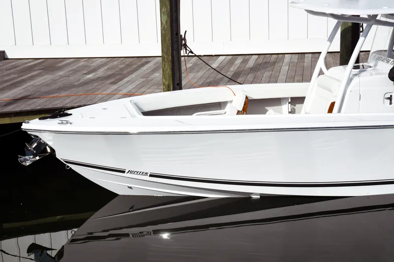Slide: The Image of 2026 Jupiter 30 boat docked, sleek white design with modern features. - 4