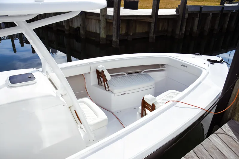 Slide: The Image of 2026 Jupiter 30 boat interior with white seating and dockside view. - 5