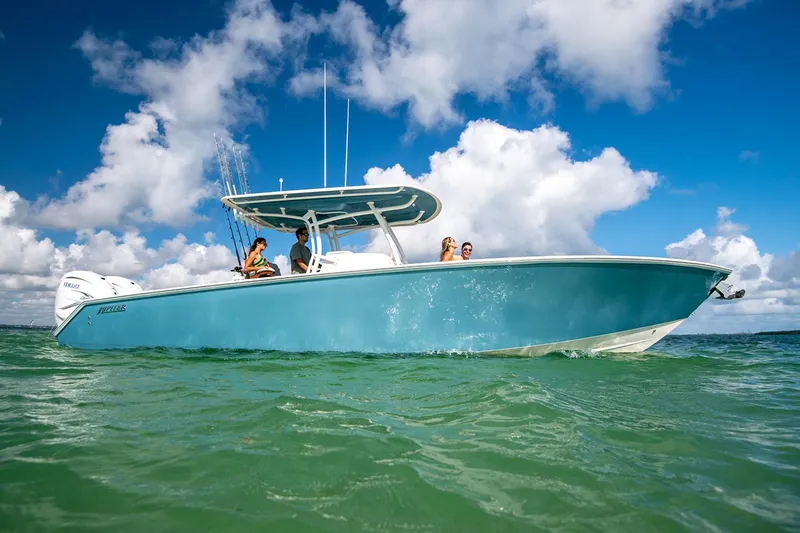 Slide: The Image of Manufacturer Provided Image: 2026 Jupiter 34 boat cruising on clear water under a bright blue sky. - 1
