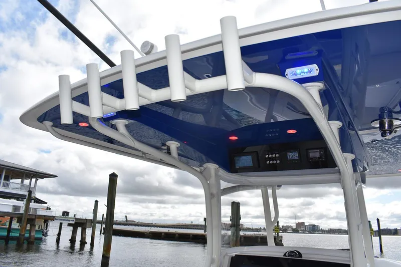 Slide: The Image of Manufacturer Provided Image: 2026 Jupiter 34 boat with rod holders and electronic controls, docked by the waterfront. - 3