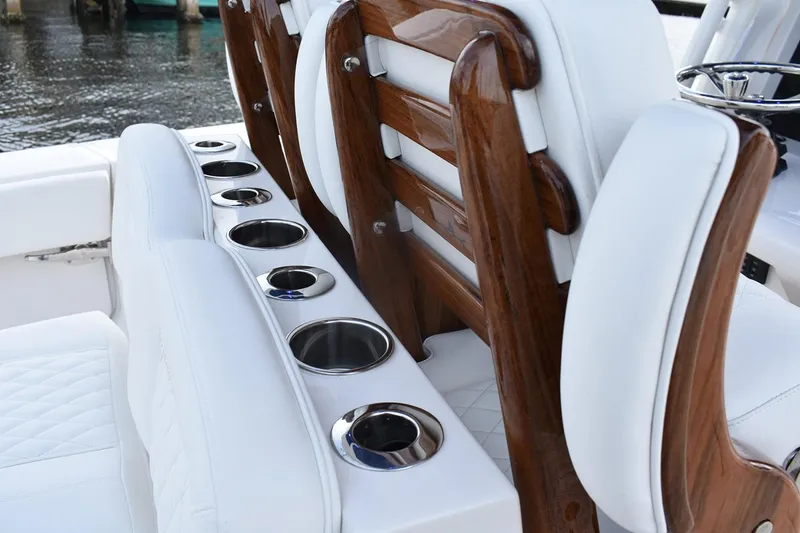 Slide: The Image of Manufacturer Provided Image: Luxury seating with cup holders on a 2026 Jupiter 34 boat, featuring elegant wood accents. - 10