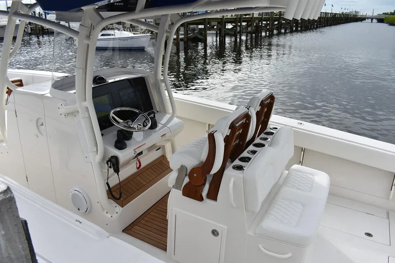 Slide: The Image of Manufacturer Provided Image: 2026 Jupiter 34 boat interior with helm, seating, and waterfront view. - 6