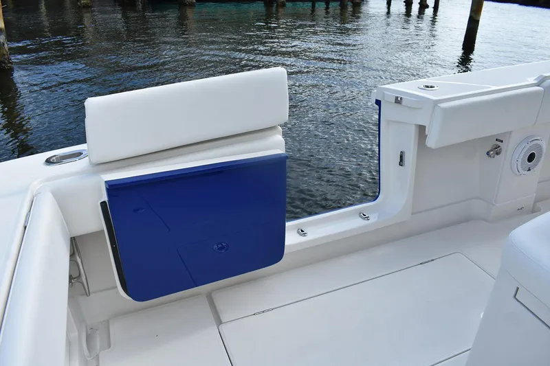 Slide: The Image of Manufacturer Provided Image: 2026 Jupiter 34 boat interior with blue and white seating, dockside view. - 4