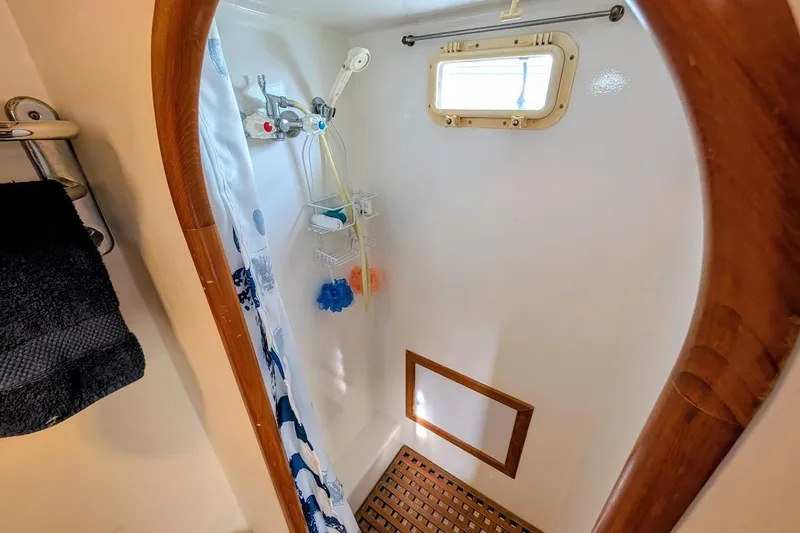 Slide: The Image of Shower area in 1987 DeFever Trawler with wooden accents and nautical decor. - 18