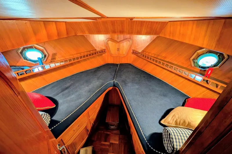 Slide: The Image of Cozy 1987 DeFever Trawler cabin with wooden interior and porthole windows. - 24