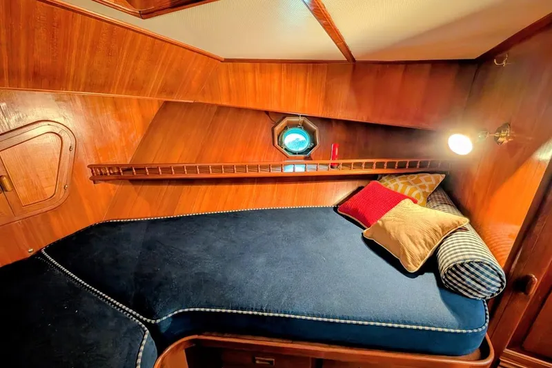 Slide: The Image of Cozy cabin interior of 1987 DeFever Trawler with wooden walls and plush bedding. - 25