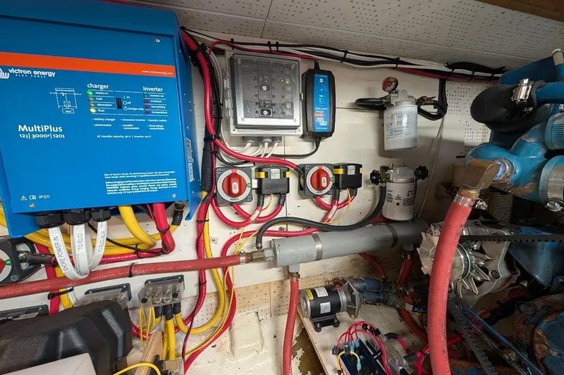 Slide: The Image of Engine room of a 1987 DeFever Trawler with electrical and mechanical components. - 46