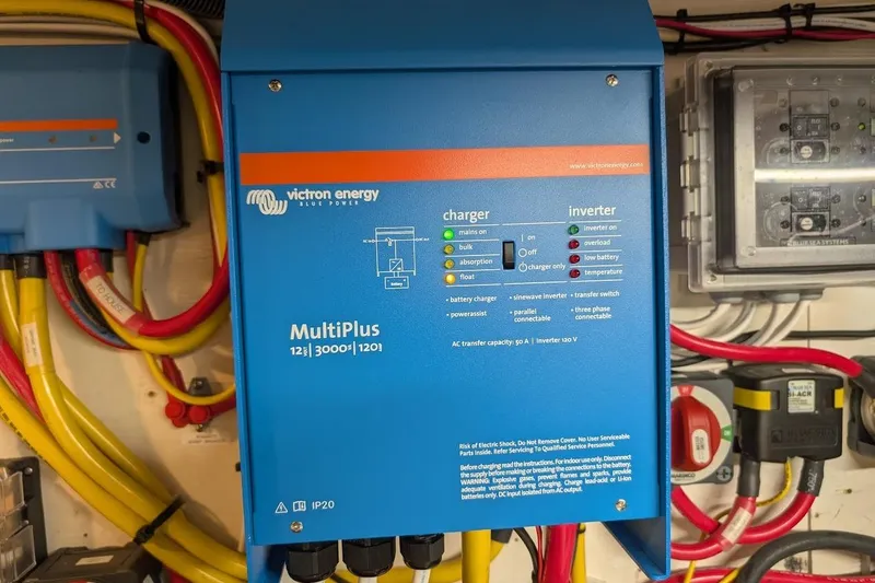 Slide: The Image of Victron Energy MultiPlus inverter charger on 1987 DeFever Trawler, surrounded by colorful cables. - 47