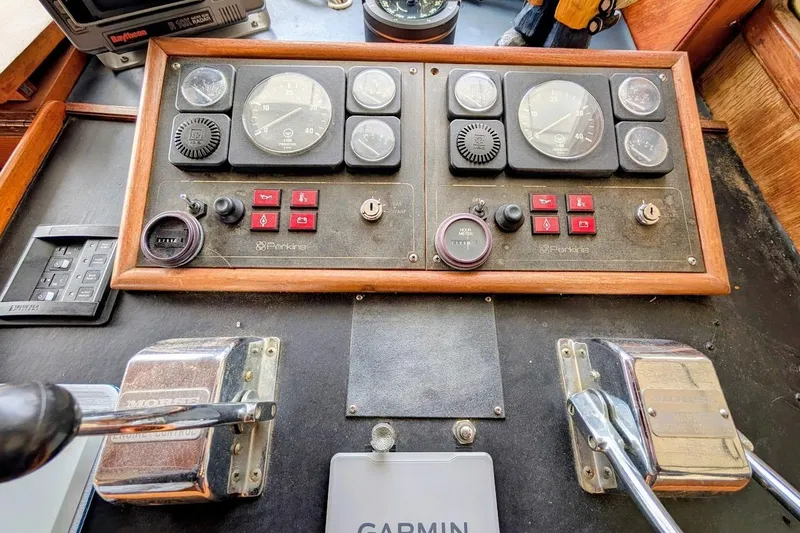 Slide: The Image of 1987 DeFever Trawler control panel with Perkins engine gauges and Garmin navigation system. - 8