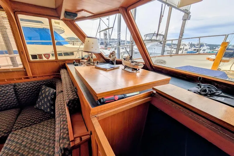 Slide: The Image of 1987 DeFever Trawler interior with wooden furnishings and marina view. - 10