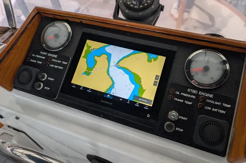 Slide: The Image of 1987 DeFever Trawler dashboard with Garmin navigation and engine gauges. - 34