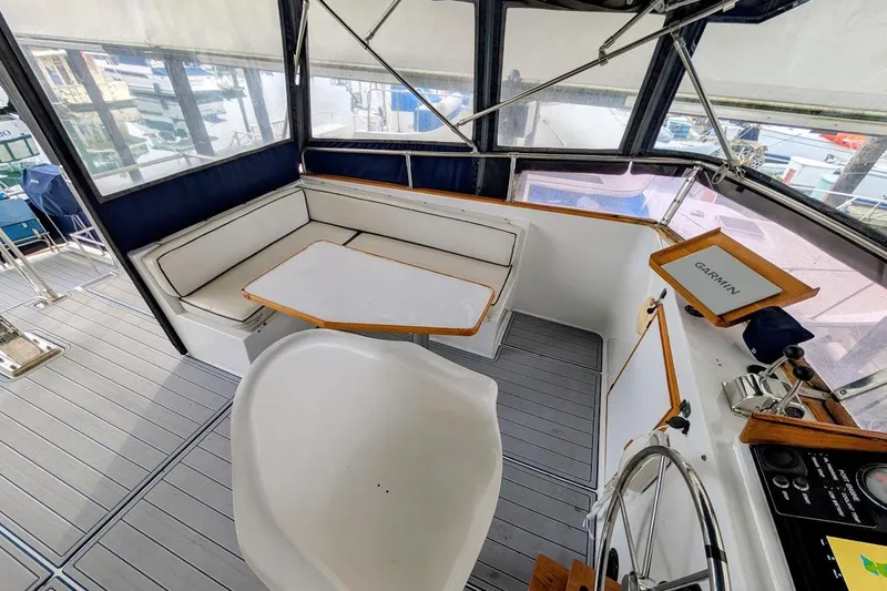 Slide: The Image of 1987 DeFever Trawler cockpit with seating, table, and navigation equipment. - 35