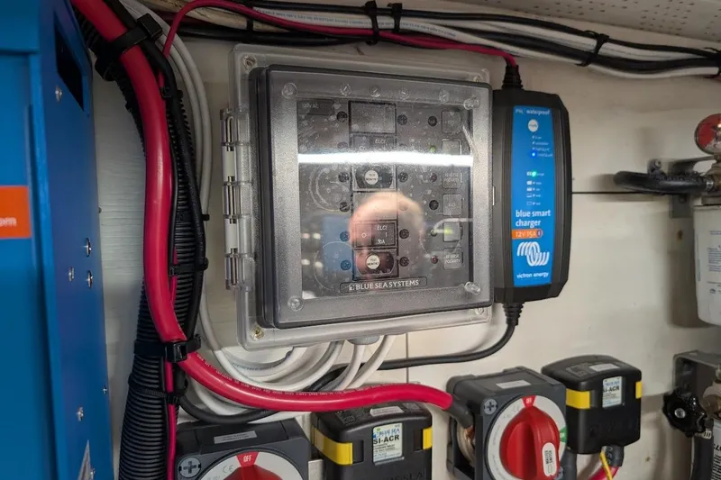 Slide: The Image of Electrical panel and charger system on a 1987 DeFever Trawler boat. - 48