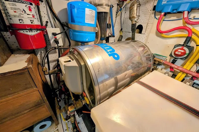 Slide: The Image of Engine room of a 1987 DeFever Trawler with equipment and fire extinguisher. - 49