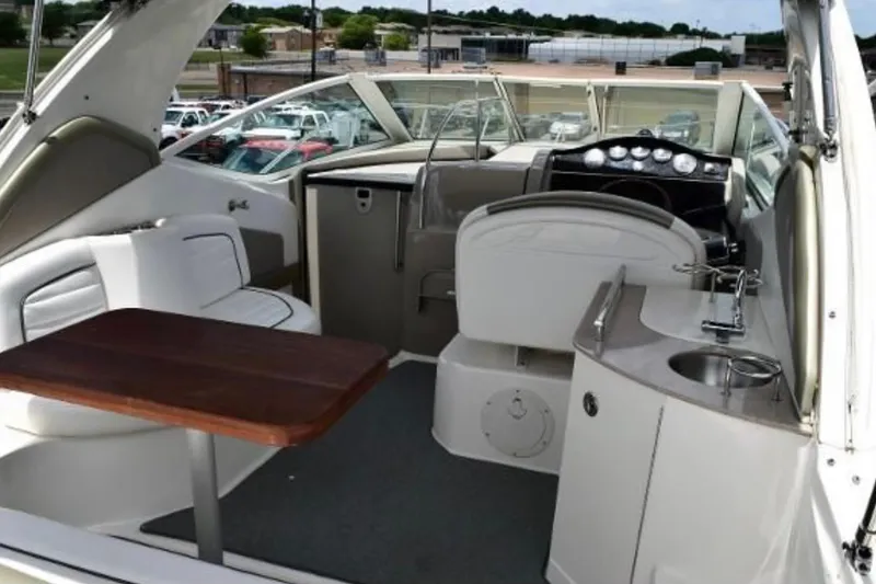 Slide: The Image of 2006 Sea Ray 290 Sundancer interior with seating, table, and helm. - 2
