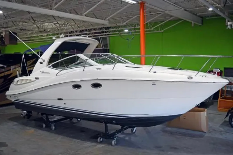 Slide: The Image of 2006 Sea Ray 290 Sundancer boat displayed indoors on a trailer. - 3