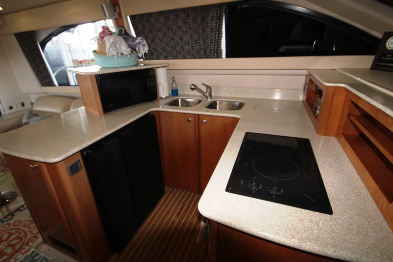 Slide: The Image of Interior of 2003 Meridian 381 Sedan yacht, kitchen with stove and sink. - 23