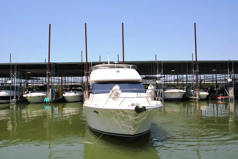 Slide: The Image of 2003 Meridian 381 Sedan docked, surrounded by boats. - 7