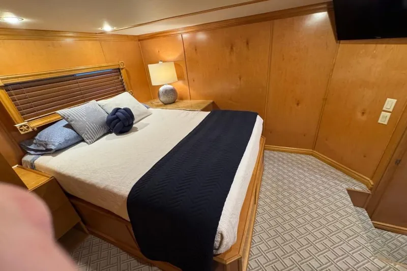 Slide: The Image of Cozy bedroom in 2009 Starlite 18 x 70 houseboat with modern decor and wooden paneling. - 10