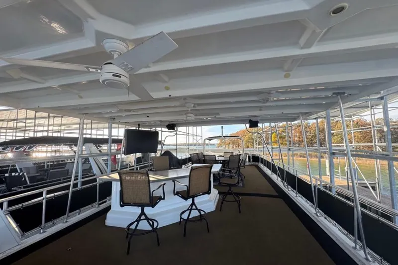 Slide: The Image of Spacious upper deck of 2009 Starlite 18 x 70 houseboat with seating and ceiling fans. - 4