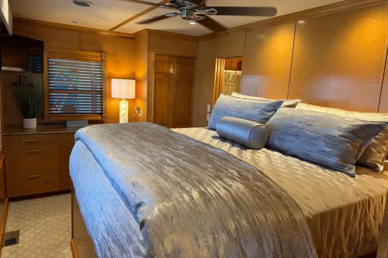 Slide: The Image of Luxurious bedroom interior of 2009 Starlite 18 x 70 houseboat with elegant bedding and warm lighting. - 8