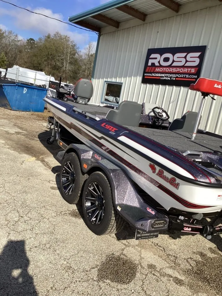 Slide: The Image of 2026 Bass Cat Puma STS boat on trailer outside building. - 2