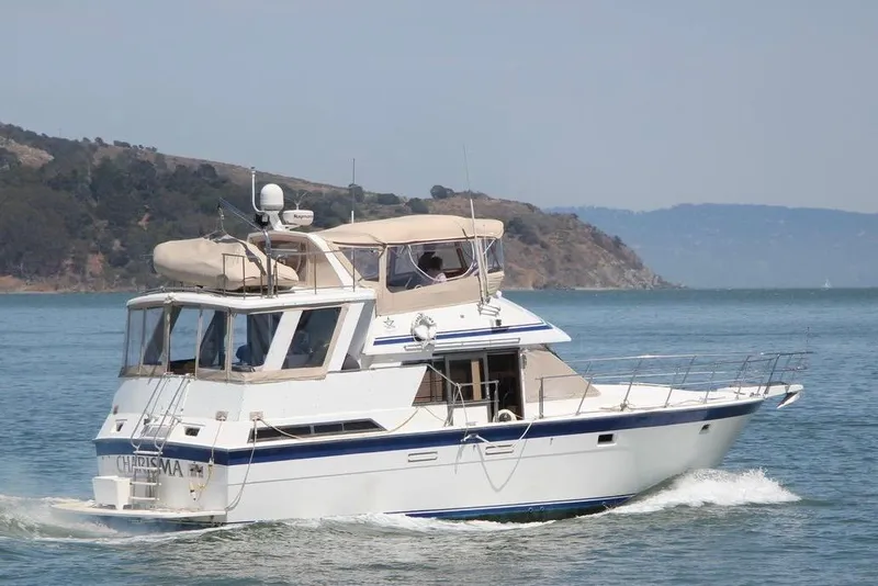 The Image of 1986 Hi Star Aft Cabin yacht cruising on a scenic waterway. - 0