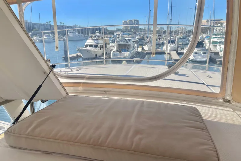 Slide: The Image of 1986 Hi-Star Aft Cabin yacht interior with marina view through windows. - 12