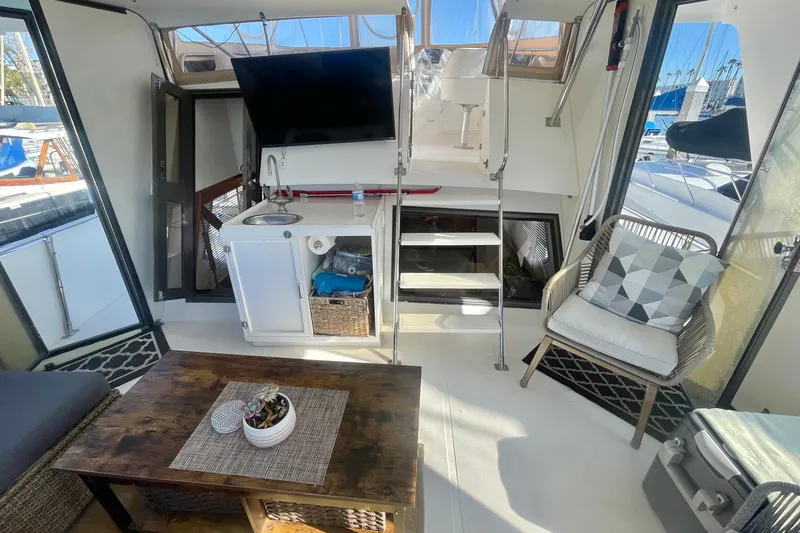 Slide: The Image of 1986 Hi-Star Aft Cabin interior with seating, table, and kitchenette. - 13