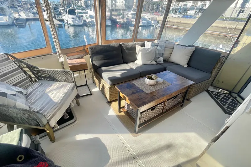 Slide: The Image of 1986 Hi-Star Aft Cabin interior with cozy seating and marina view. - 14