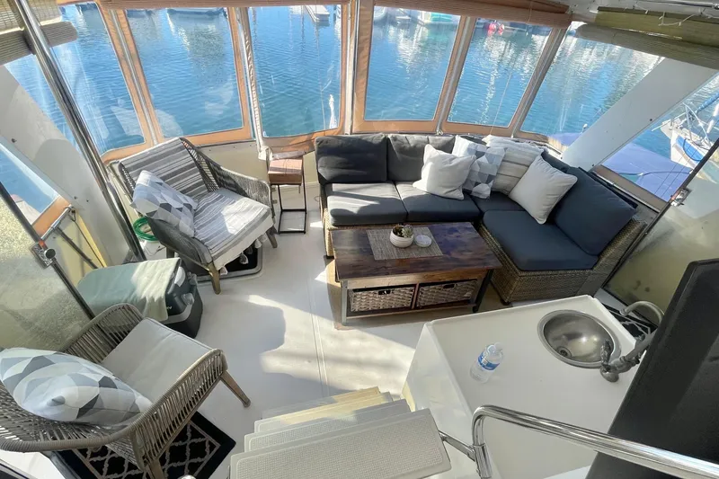 Slide: The Image of 1986 Hi-Star Aft Cabin interior with cozy seating and waterfront view. - 15