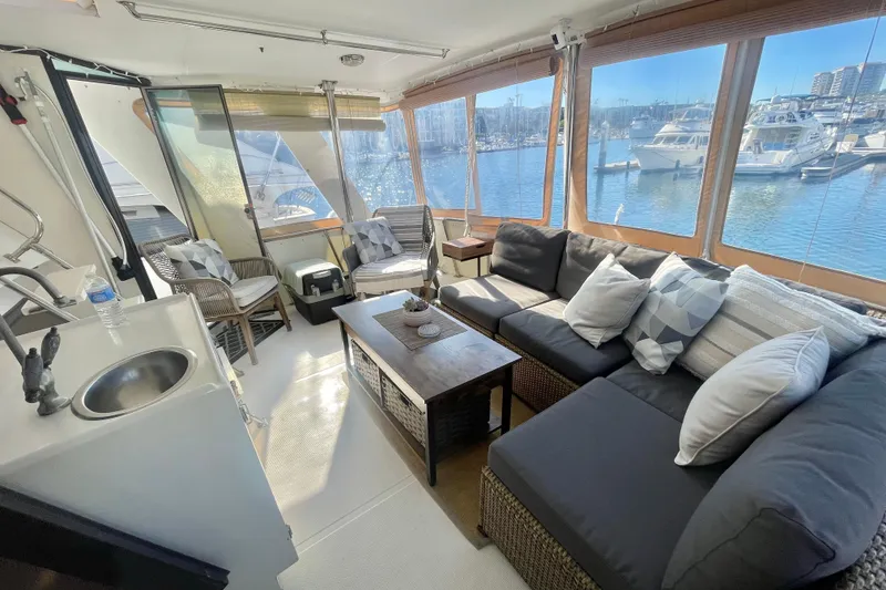 Slide: The Image of 1986 Hi-Star Aft Cabin yacht interior with cozy seating and marina view. - 17