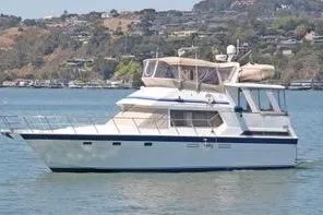 Slide: The Image of 1986 Hi Star Aft Cabin yacht on calm water with scenic background. - 2