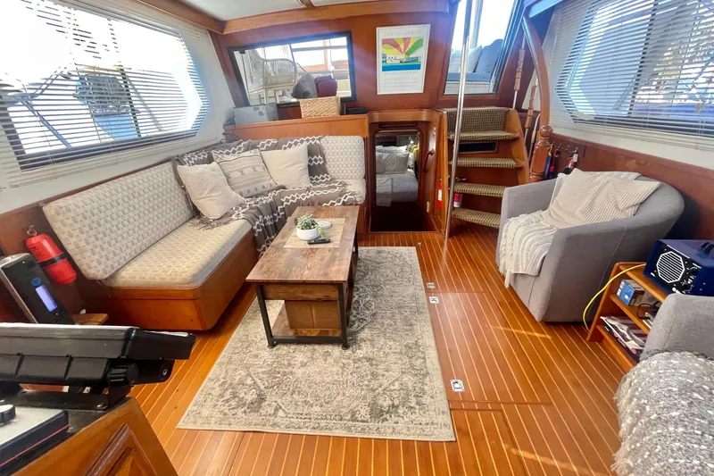 Slide: The Image of 1986 Hi-Star Aft Cabin interior with cozy seating, wooden flooring, and nautical decor. - 21