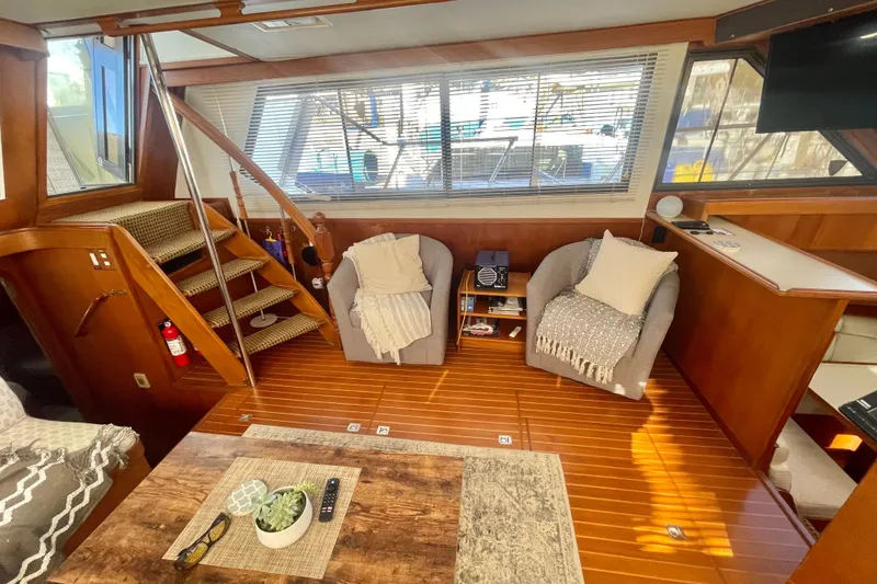 Slide: The Image of 1986 Hi-Star Aft Cabin interior with cozy seating, wooden flooring, and nautical decor. - 25