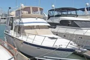 Slide: The Image of 1986 Hi Star Aft Cabin yacht docked at marina under clear blue sky. - 3