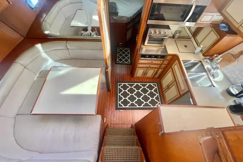 Slide: The Image of Interior of 1986 Hi-Star Aft Cabin yacht with kitchen and dining area. - 30