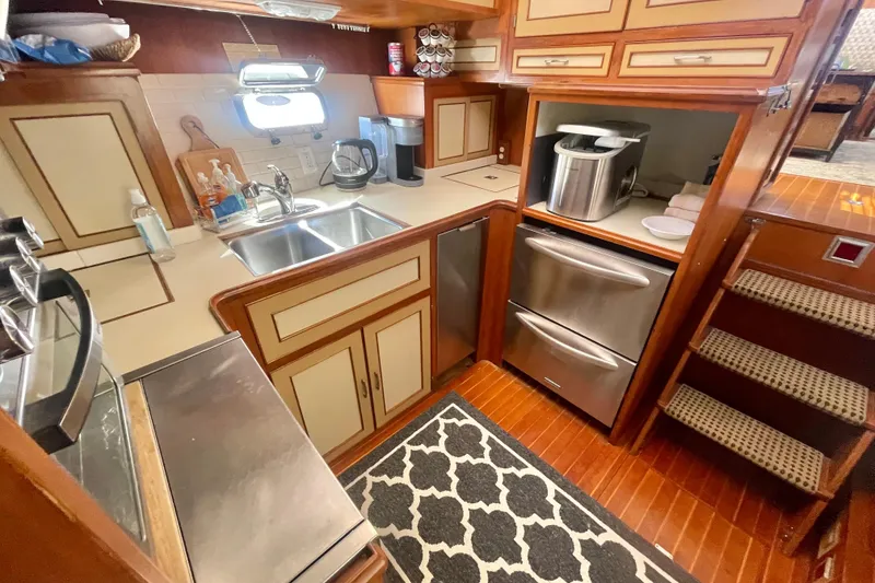 Slide: The Image of 1986 Hi-Star Aft Cabin kitchen with stainless steel appliances and wooden cabinetry. - 31