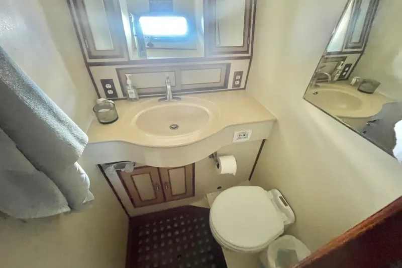 Slide: The Image of 1986 Hi-Star Aft Cabin bathroom with sink, mirror, and toilet. - 35
