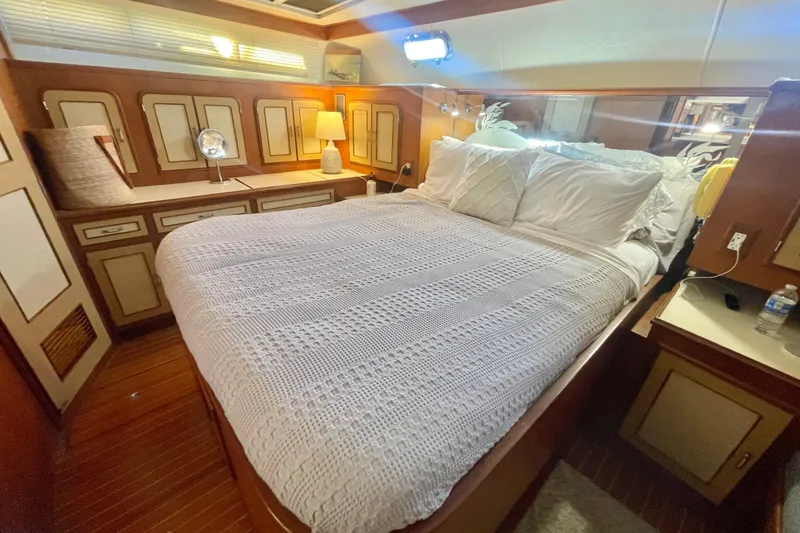 Slide: The Image of Luxurious 1986 Hi-Star Aft Cabin bedroom with cozy bedding and elegant wood paneling. - 36