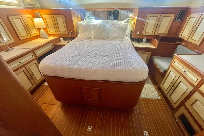 Slide: The Image of 1986 Hi-Star Aft Cabin bedroom with cozy bed, wooden cabinetry, and ambient lighting. - 37