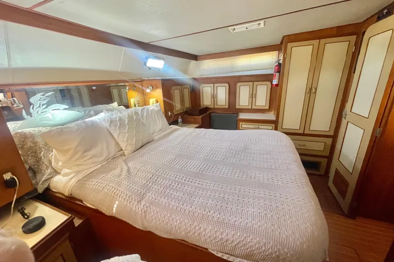 Slide: The Image of Luxurious 1986 Hi-Star Aft Cabin bedroom with cozy bedding and elegant wood cabinetry. - 38