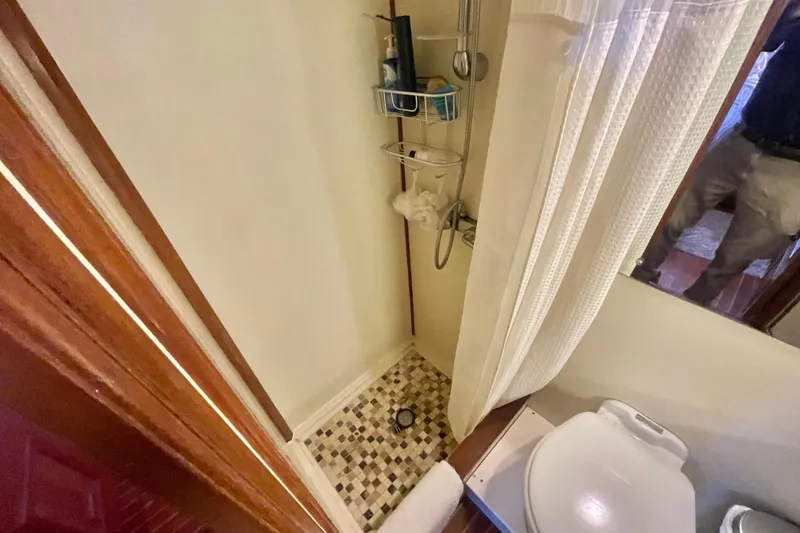 Slide: The Image of 1986 Hi-Star Aft Cabin bathroom with shower, curtain, and tiled floor. - 40