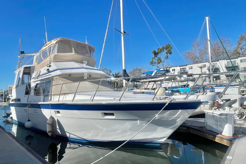 Slide: The Image of 1986 Hi Star Aft Cabin yacht docked at marina under clear blue sky. - 5