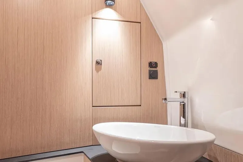 Slide: The Image of Modern bathroom interior of 2023 Bavaria Vida 33 yacht with sleek sink and wood paneling. - 11