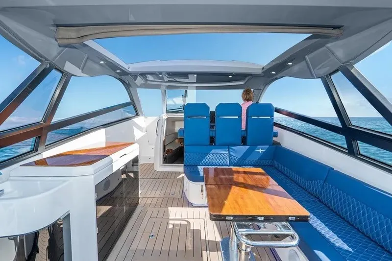Slide: The Image of Interior of 2023 Bavaria Vida 33 yacht with blue seating and wooden table. - 6