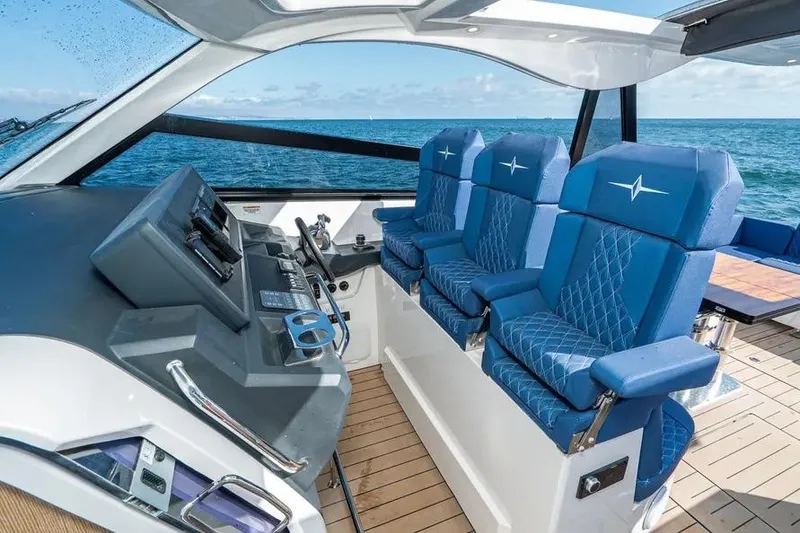 Slide: The Image of 2023 Bavaria Vida 33 yacht cockpit with blue seats and ocean view. - 7