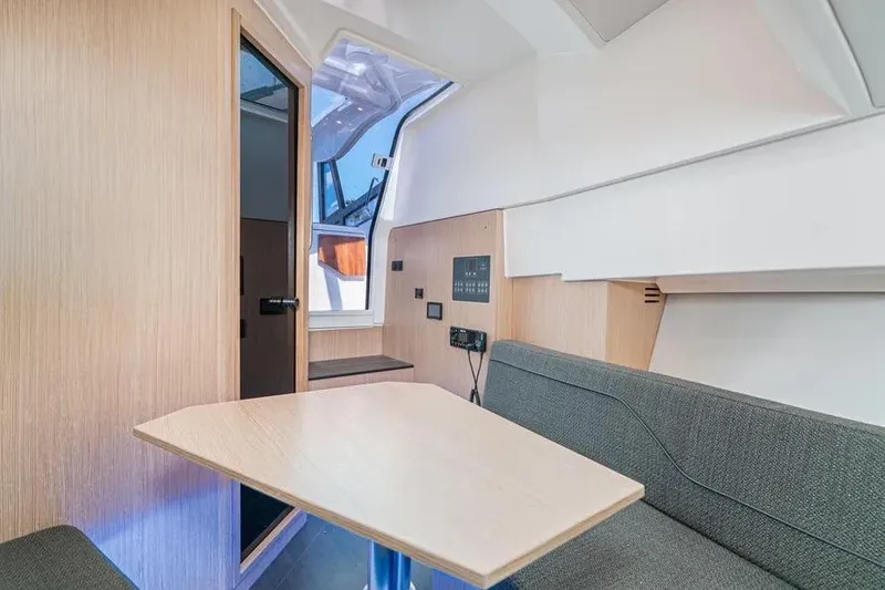 Slide: The Image of 2023 Bavaria Vida 33 interior with modern seating and wooden table. - 9